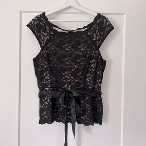 Wear it to a wedding or New Year’s Eve!  Elegant black lack top.